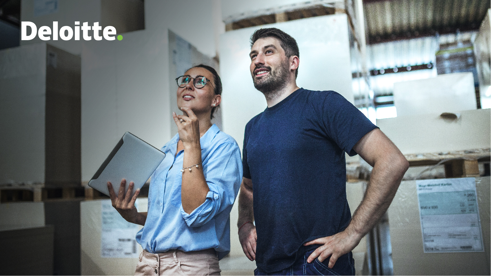 Man and woman with a clipboard inspecting a warehouse