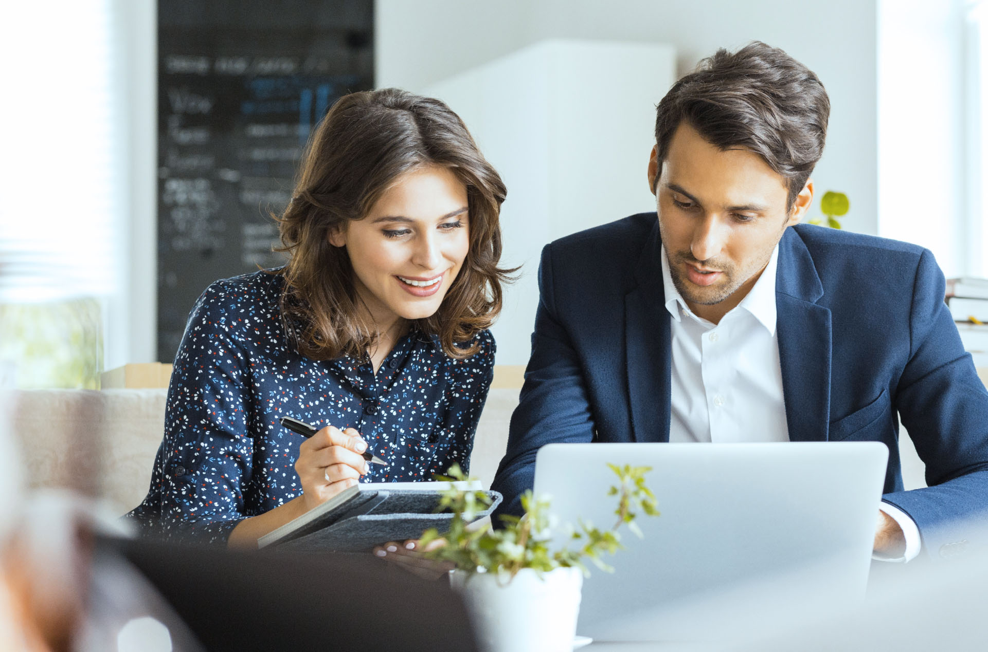 Colleagues collaborating on laptop in a business setting