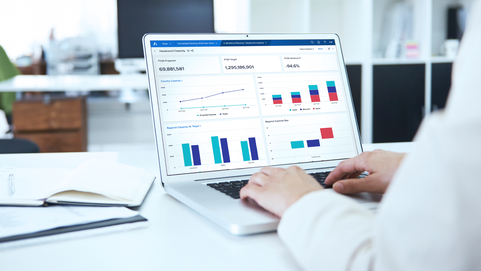 two hands typing on computer showing anaplan dashboard