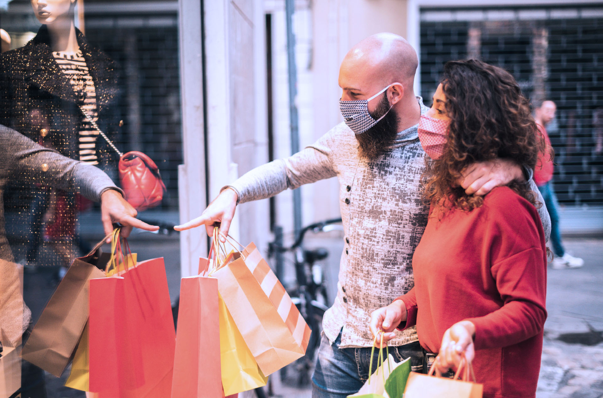 Man and woman window shopping holding shopping bags