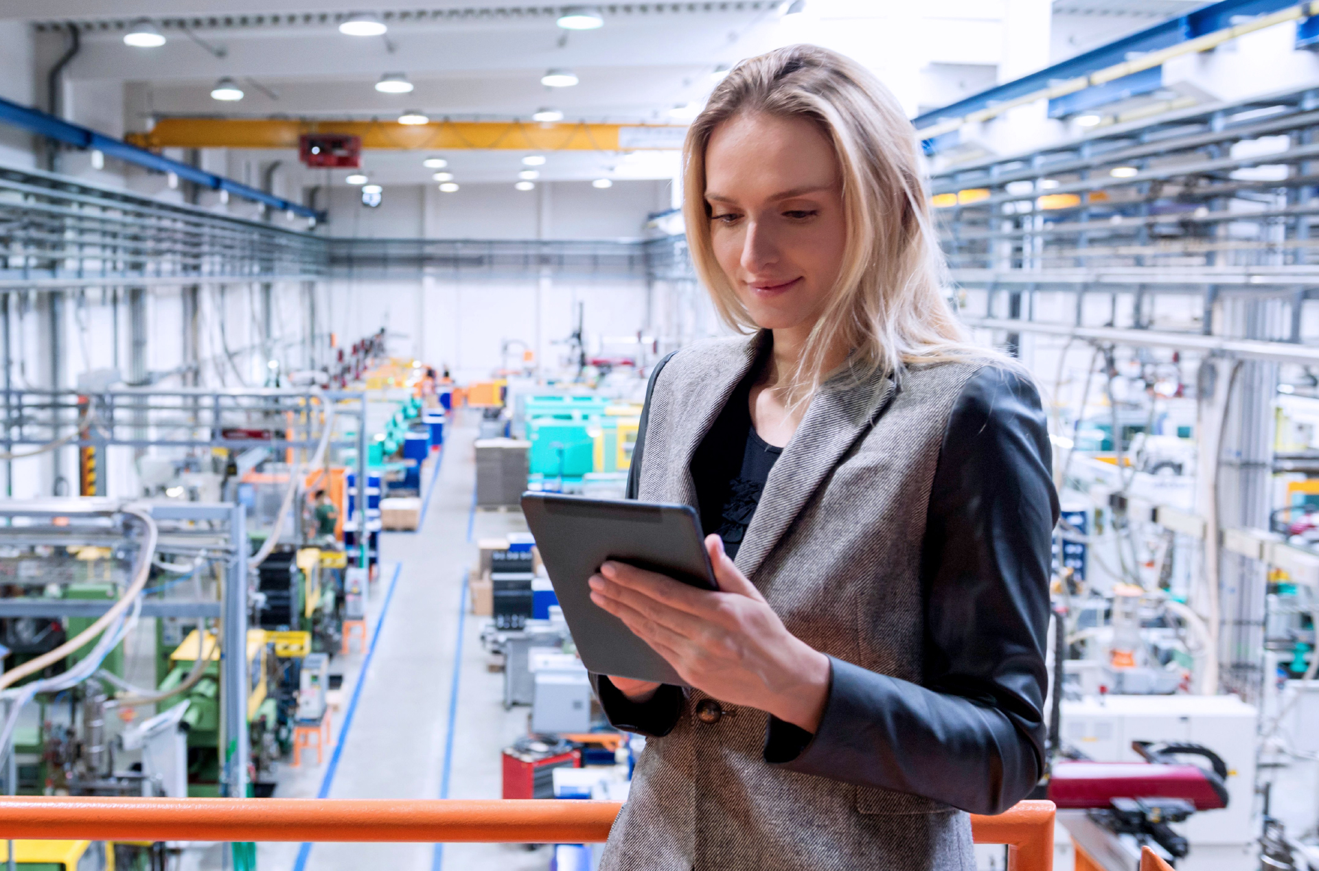 woman with tablet in manufacturing plant