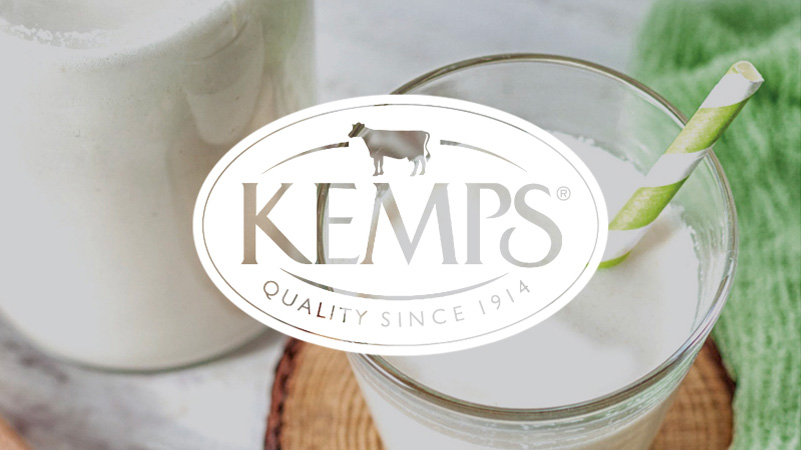 Kemps Logo over glass of milk