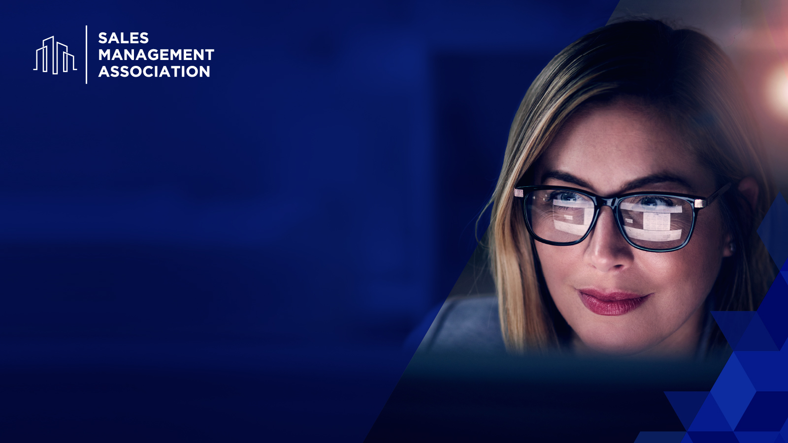 Woman wearing glasses reflecting the work she does on the computer