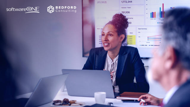 Woman conversing with others around a conference table