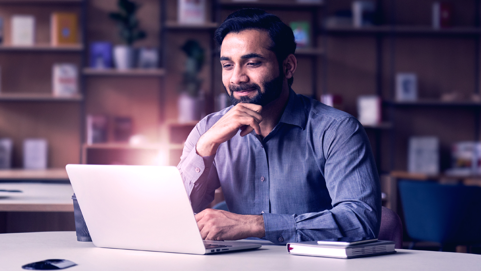 Man smiling looking down at laptop