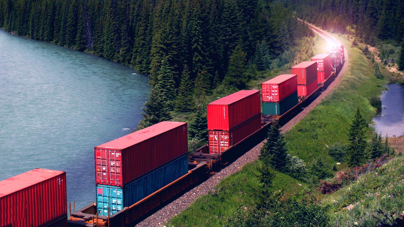Shipping containers on a train in a mountain pass