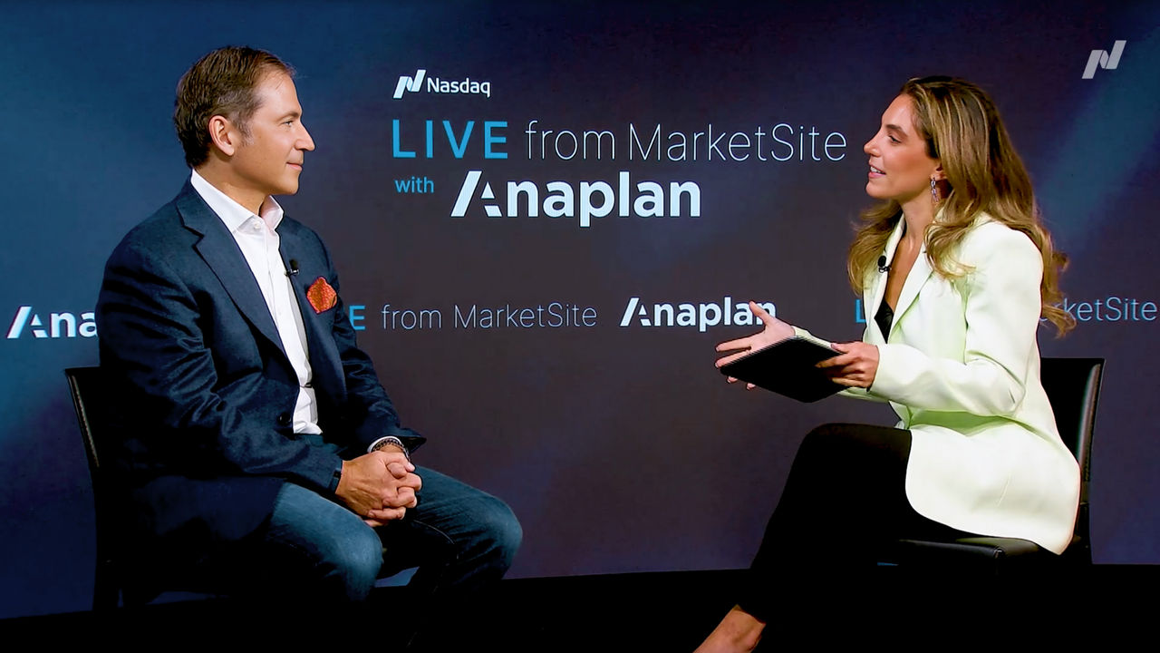 Anaplan CEO Charlie Gottdiener speaking in a live interview at Nasdaq MarketSite, seated across from a female interviewer holding a notepad, with “LIVE from MarketSite with Anaplan” displayed on the background screen.