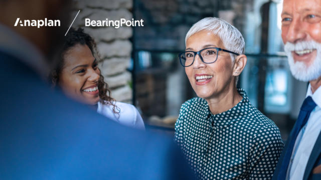 Business woman with short, silver hair listening intently in casual meeting