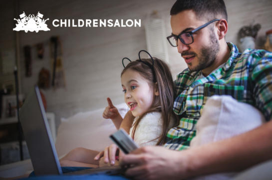 Father sitting with his daughter in front of laptop
