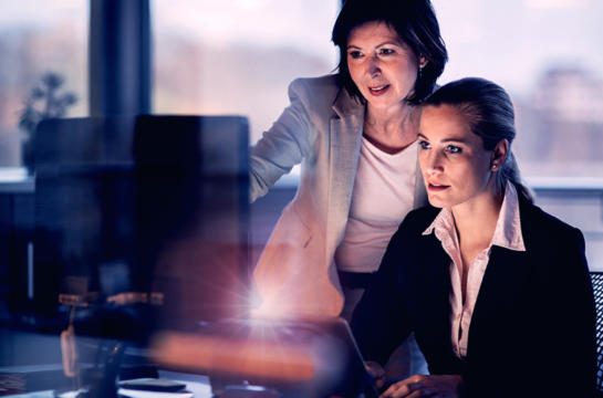 Manager shadowing employee while they make updates to a reporting model
