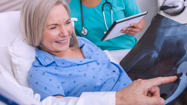 Woman pleasantly going over some test results with her doctor