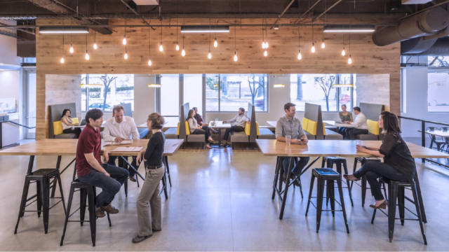 Open floor collaborative space with people of various backgrounds working together, office setting