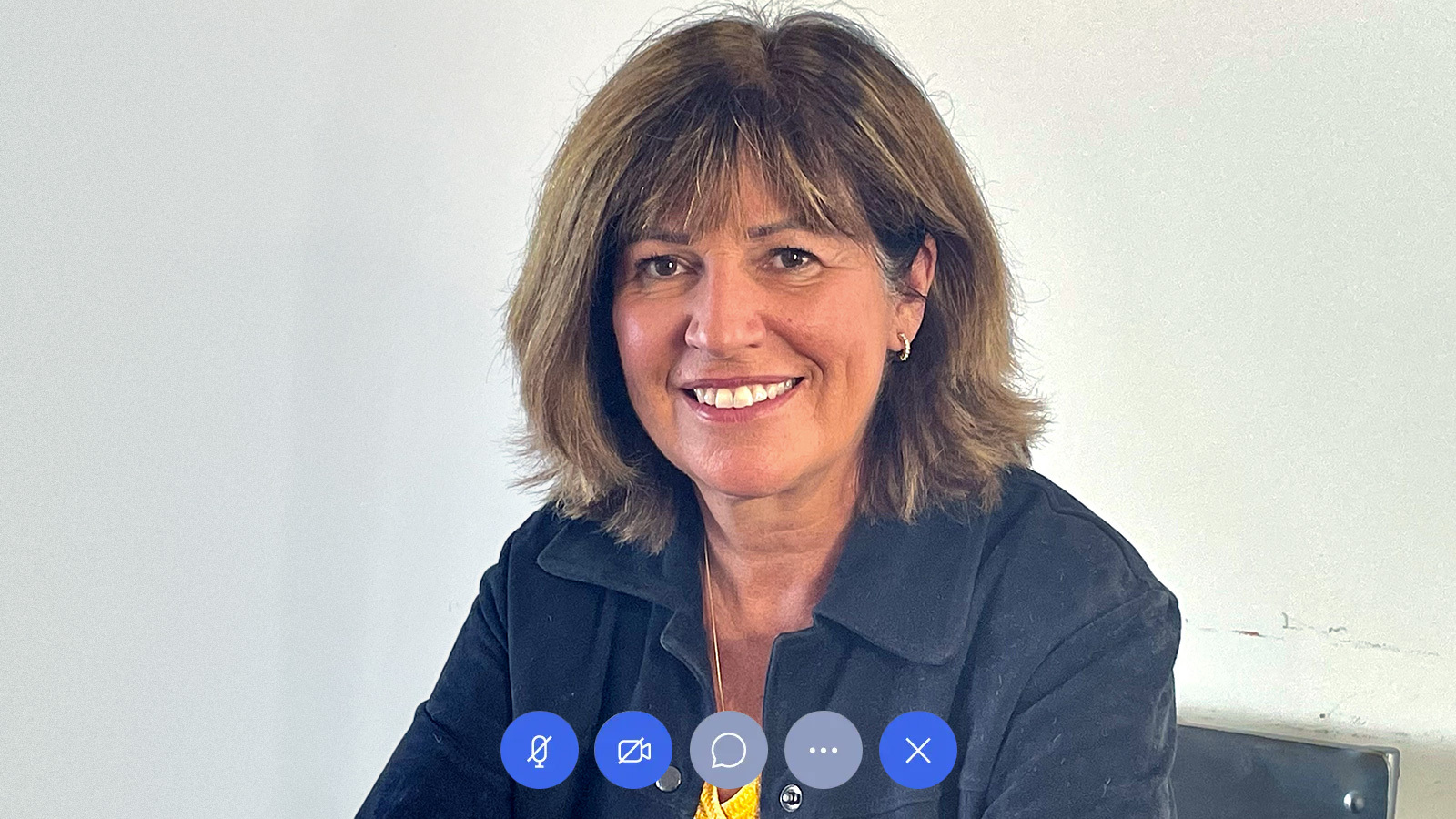 Nadine Pichelot, professional business woman wearing jacket with a zoom meeting user interface overlay